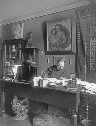 French composer Jules Massenet sitting at his desk by Dornac